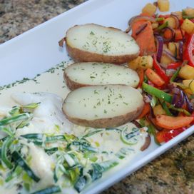 Steamed cod with leek sauce and vegetables